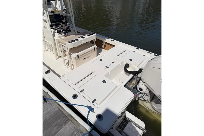 Slide: The Image of 2022 Pathfinder 2200 TRS boat docked, showcasing deck and seating area. - 31