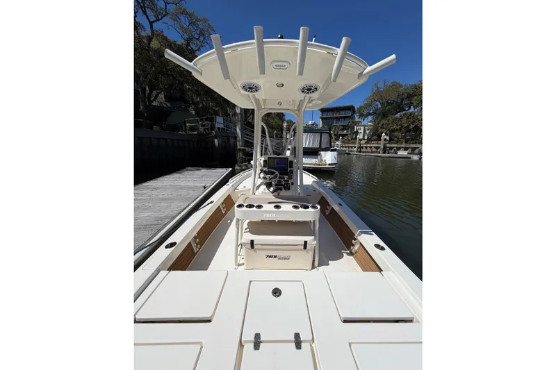 Slide: The Image of 2022 Pathfinder 2200 TRS boat docked, featuring center console and T-top. - 32
