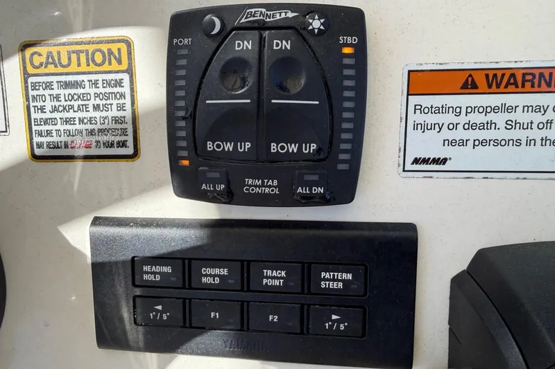 Slide: The Image of Control panel of a 2022 Pathfinder 2200 TRS boat with caution and warning labels. - 40