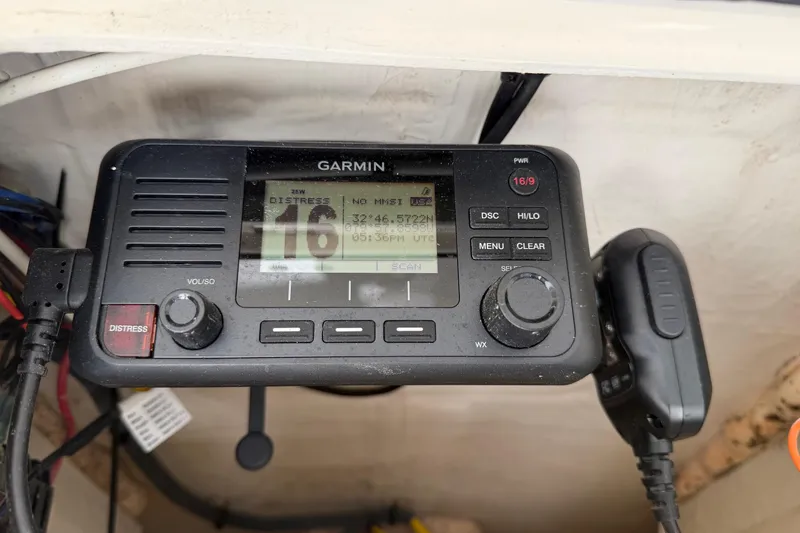 Slide: The Image of Garmin marine radio on a 2022 Pathfinder 2200 TRS, displaying distress channel 16. - 42