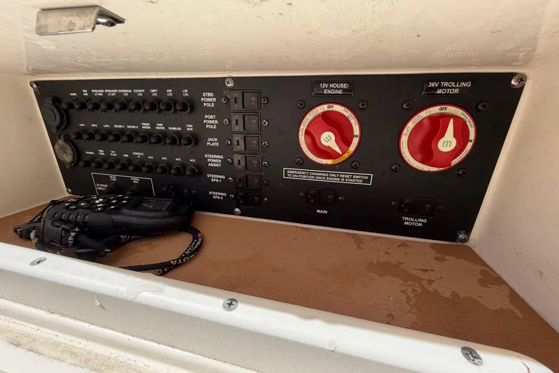 Slide: The Image of Control panel of a 2022 Pathfinder 2200 TRS boat with switches and radio. - 45