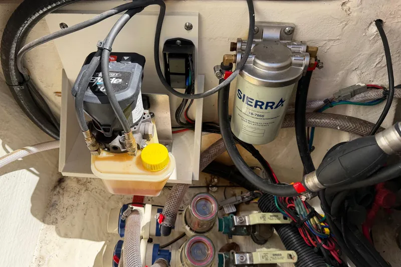 Slide: The Image of Boat engine compartment with Sierra fuel filter and hydraulic system, Pathfinder 2200 TRS 2022 model. - 49
