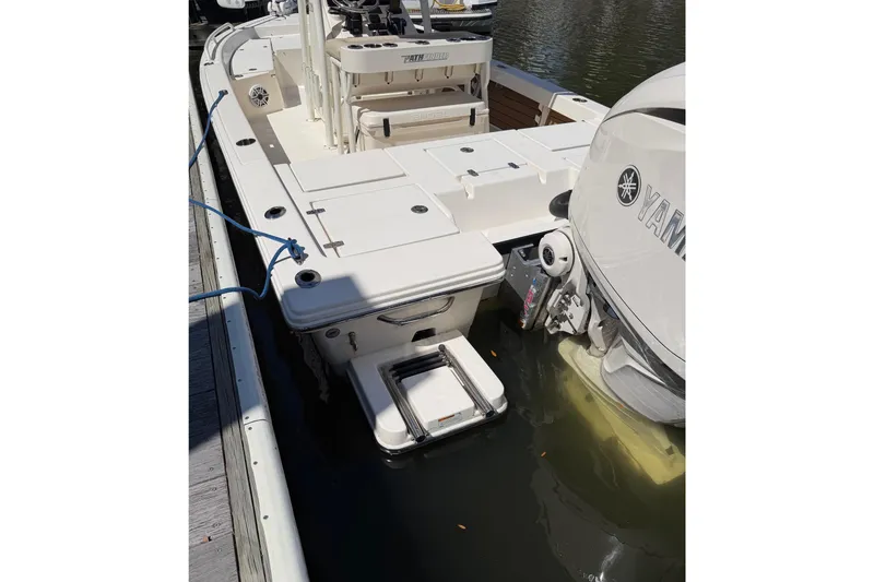 Slide: The Image of 2022 Pathfinder 2200 TRS boat docked, featuring Yamaha outboard motor and swim platform. - 51