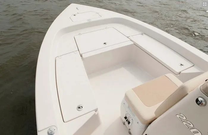 Slide: The Image of Manufacturer Provided Image: 2022 Pathfinder 2200 TRS boat interior with storage compartments on water. - 57