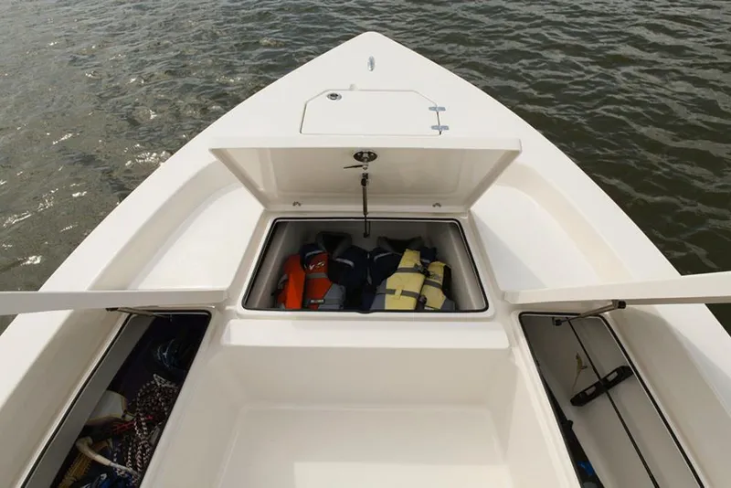 Slide: The Image of Manufacturer Provided Image: 2022 Pathfinder 2200 TRS boat storage compartments with life jackets on water. - 58
