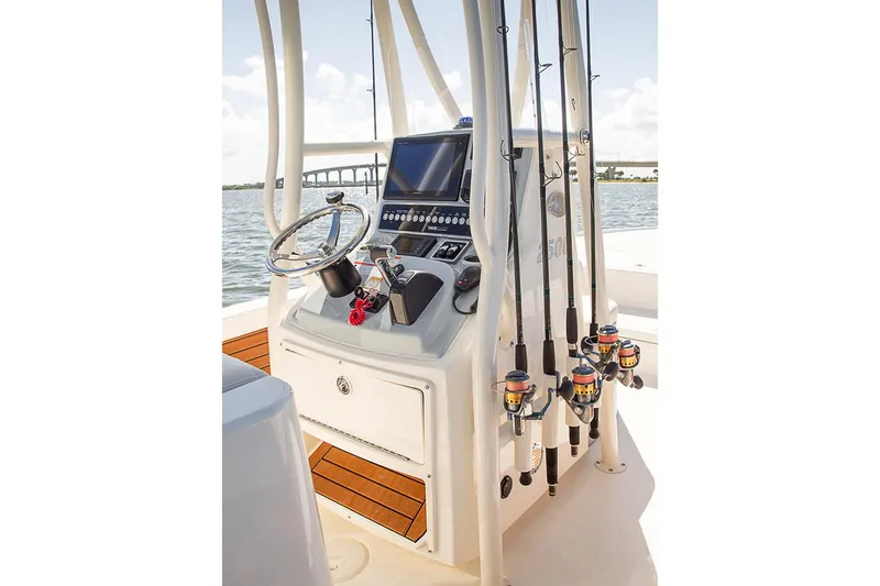 Slide: The Image of Manufacturer Provided Image: 2022 Pathfinder 2200 TRS boat console with steering wheel, electronics, and fishing rods. - 61