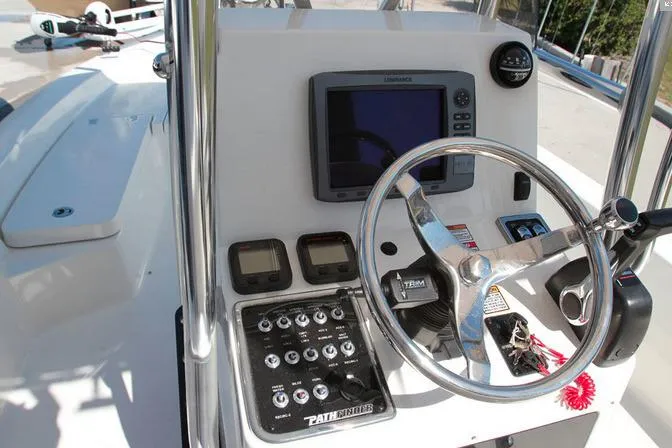 Slide: The Image of Manufacturer Provided Image: 2022 Pathfinder 2200 TRS boat dashboard with steering wheel, navigation system, and control panel. - 62