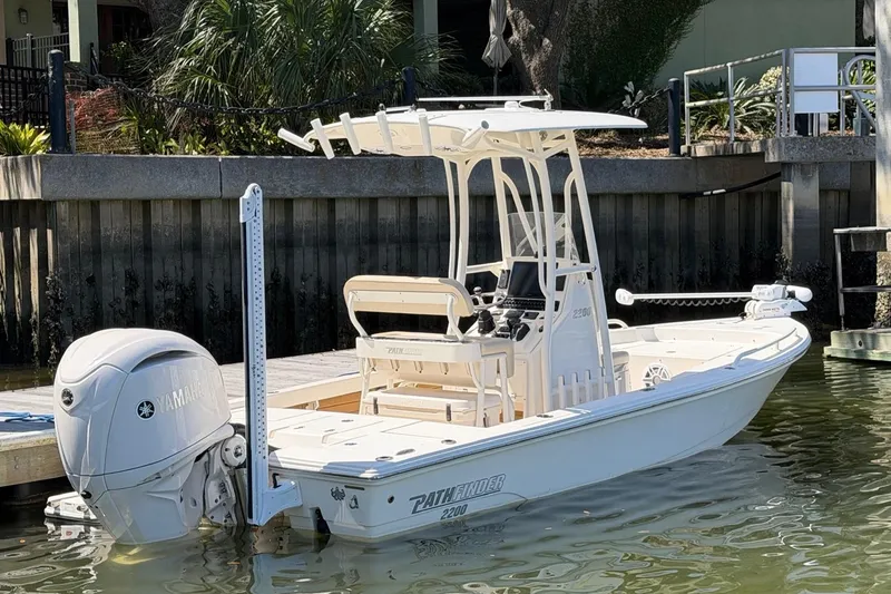 Slide: The Image of 2022 Pathfinder 2200 TRS boat docked, featuring Yamaha outboard motor and sleek design. - 7