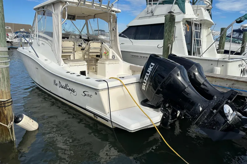 Slide: The Image of 2001 Scout 280 Abaco boat docked with Suzuki outboard motors. - 1