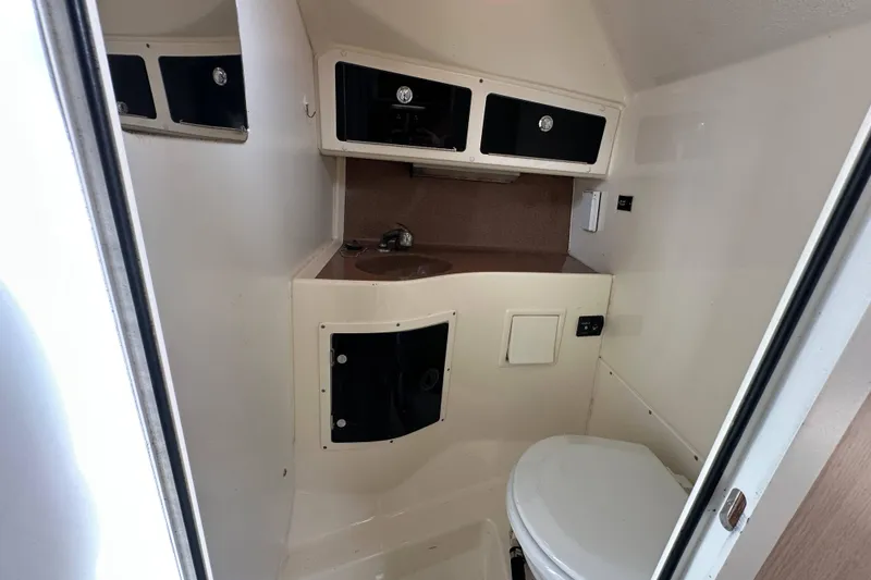 Slide: The Image of Interior of 2001 Scout 280 Abaco boat bathroom with sink and storage cabinets. - 10