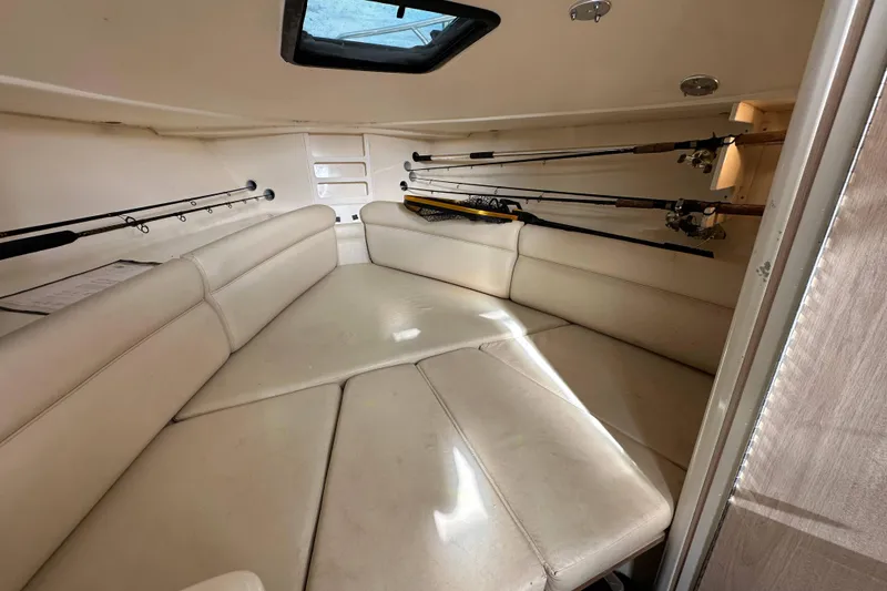 Slide: The Image of Interior cabin of 2001 Scout 280 Abaco boat with fishing rods and seating. - 11