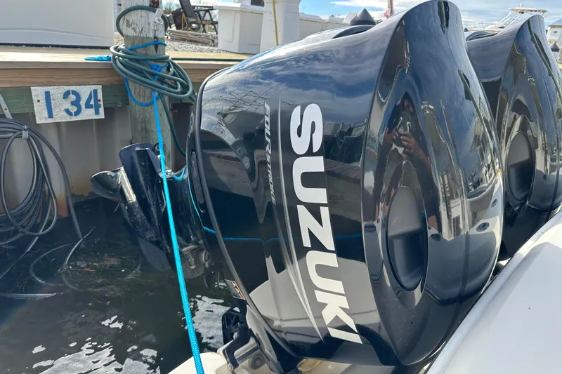 Slide: The Image of Twin Suzuki outboard motors on a 2001 Scout 280 Abaco boat at dock. - 14