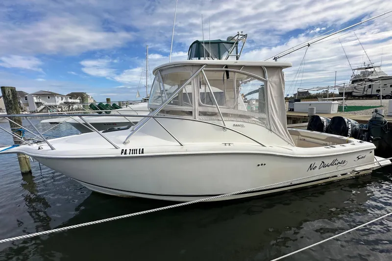 Slide: The Image of 2001 Scout 280 Abaco boat docked at marina under cloudy sky. - 3