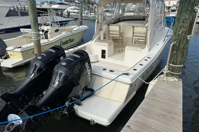 Slide: The Image of 2001 Scout 280 Abaco boat docked with dual Suzuki engines, featuring spacious seating. - 4