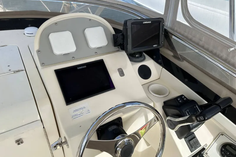 Slide: The Image of Helm of 2001 Scout 280 Abaco boat with navigation equipment and steering wheel. - 6