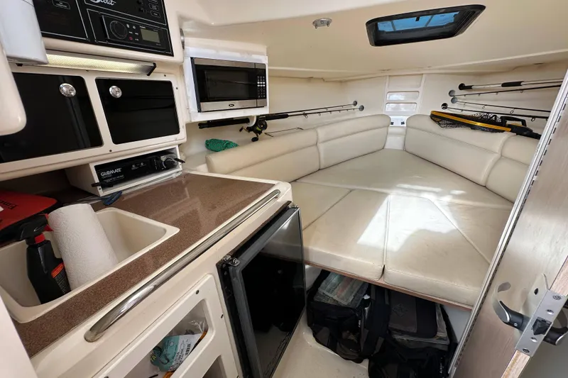 Slide: The Image of Interior of 2001 Scout 280 Abaco boat with kitchenette and seating area. - 8