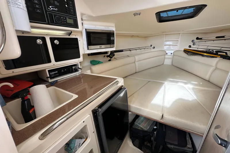 Slide: The Image of Interior of 2001 Scout 280 Abaco boat with kitchenette and seating area. - 9