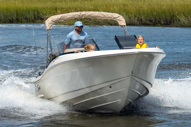 Slide: The Image of Manufacturer Provided Image: 2026 Scout 220 Dorado boat cruising on water with passengers enjoying the ride. - 2