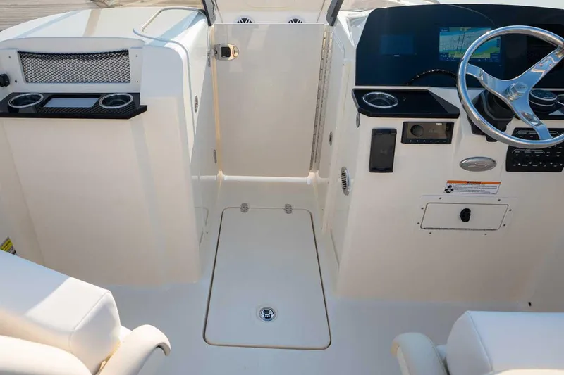 Slide: The Image of Manufacturer Provided Image: 2026 Scout 220 Dorado boat interior with steering wheel and navigation display. - 7