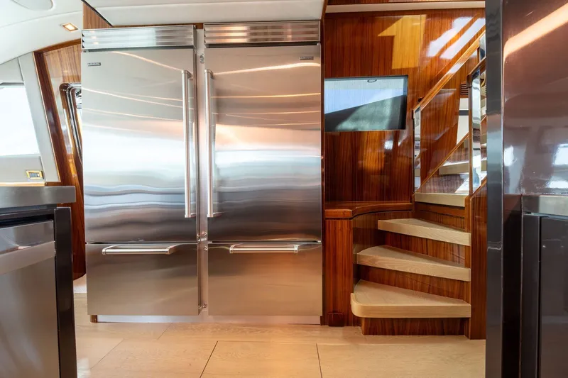 Slide: The Image of Luxury yacht kitchen with stainless steel fridge and wooden staircase, Horizon E88, 2013. - 8