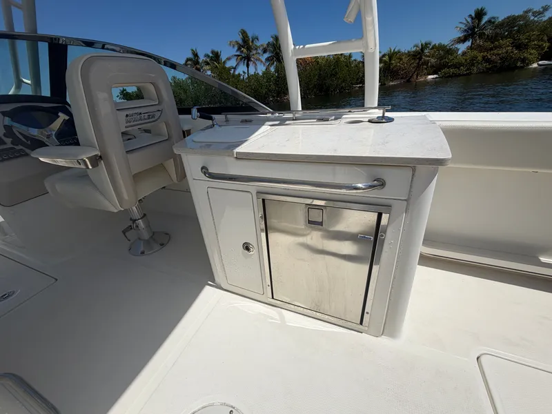 Slide: The Image of Interior of a 2016 Boston Whaler 270 Vantage boat with seat and cabinet. - 17