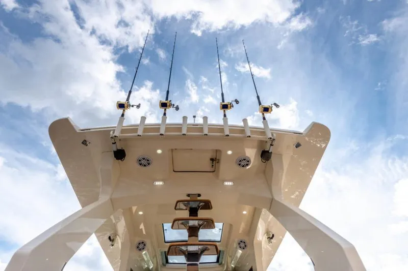 Slide: The Image of Manufacturer Provided Image: 2025 Scout 530 LXF boat with fishing rods against a blue sky. - 14