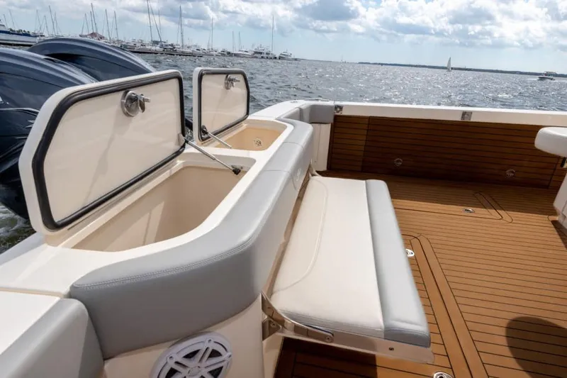 Slide: The Image of Manufacturer Provided Image: 2025 Scout 530 LXF boat interior with seating and storage, docked at marina. - 20