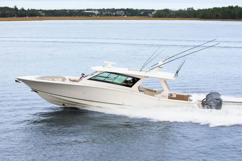 Slide: The Image of Manufacturer Provided Image: 2025 Scout 530 LXF luxury boat cruising on open water. - 3