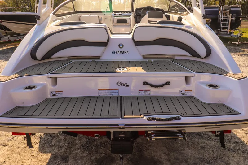 Slide: The Image of 2024 Yamaha Boats AR195 rear view with spacious swim platform and seating. - 10