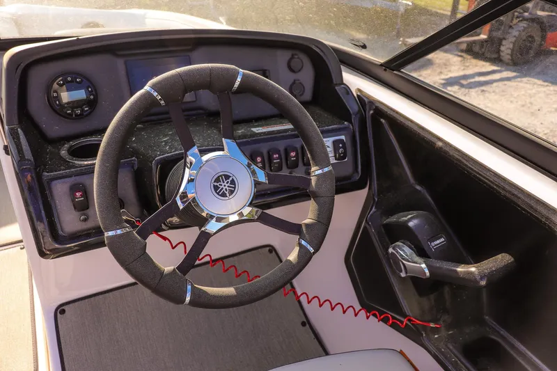 Slide: The Image of 2024 Yamaha Boats AR195 steering wheel and dashboard controls. - 11