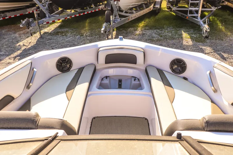 Slide: The Image of 2024 Yamaha Boats AR195 interior with cushioned seating and speakers. - 12