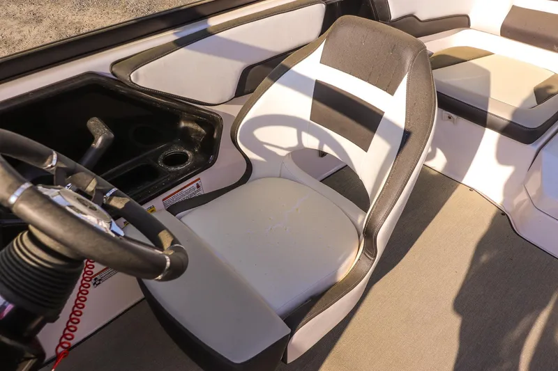 Slide: The Image of 2024 Yamaha Boats AR195 interior with steering wheel and seating area. - 14