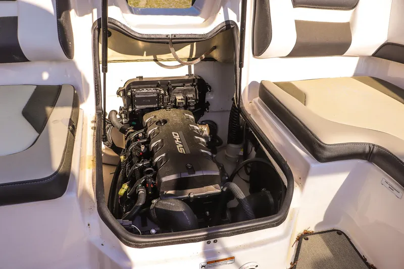 Slide: The Image of 2024 Yamaha Boats AR195 engine compartment with visible engine components and seating area. - 15