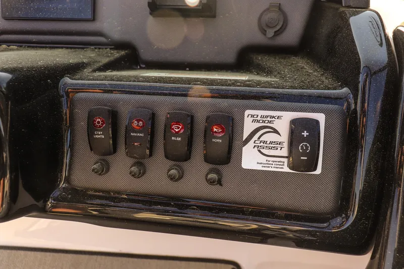 Slide: The Image of Control panel of 2024 Yamaha Boats AR195 featuring various switches and Cruise Assist. - 18