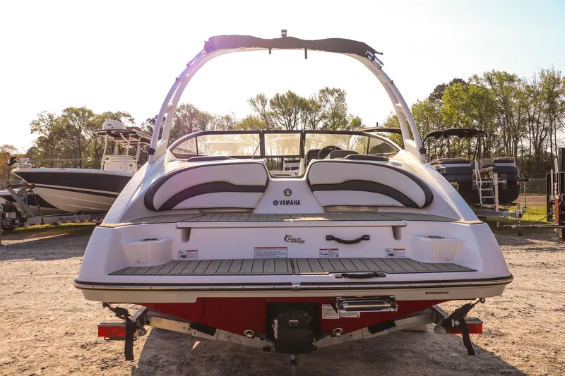 Slide: The Image of 2024 Yamaha Boats AR195, rear view, parked outdoors, showcasing sleek design and features. - 4