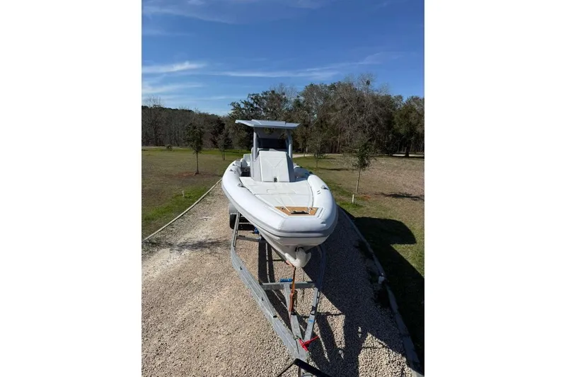 Slide: The Image of 2026 Novielli Veloche 349 boat on trailer, parked outdoors under clear blue sky. - 10