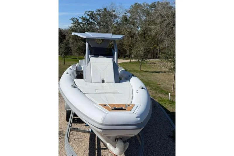 Slide: The Image of 2026 Novielli Veloche 349 boat on trailer, parked outdoors with trees in background. - 11