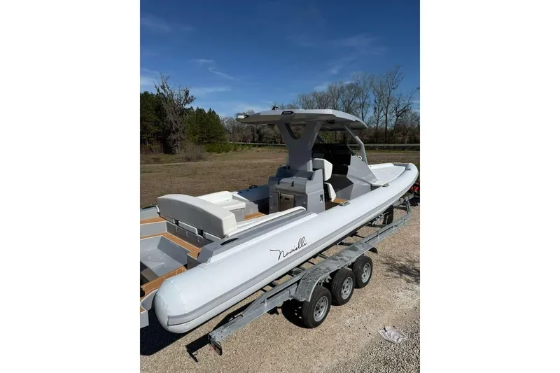 Slide: The Image of Novielli Veloche 349 boat on trailer, 2026 model, parked outdoors under clear sky. - 12