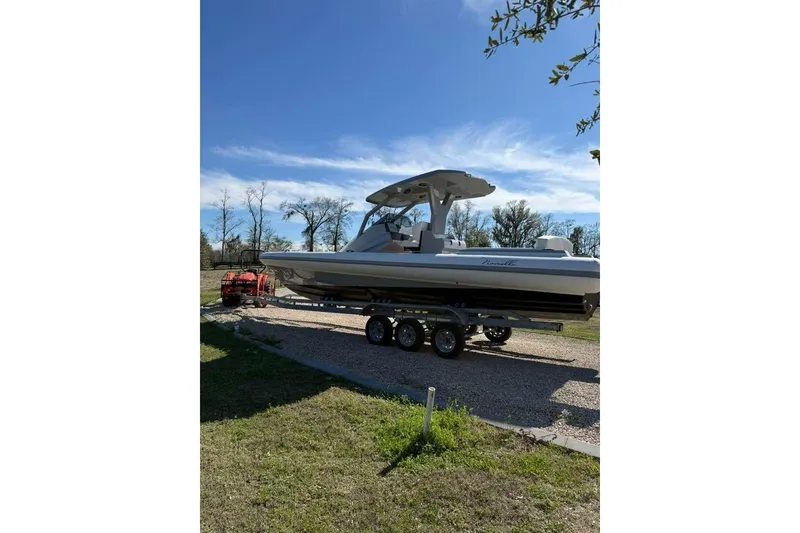 Slide: The Image of 2026 Novielli Veloche 349 boat on trailer under clear blue sky. - 2