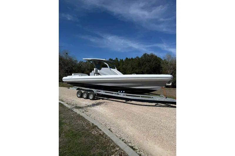 Slide: The Image of 2026 Novielli Veloche 349 boat on trailer under clear blue sky. - 4