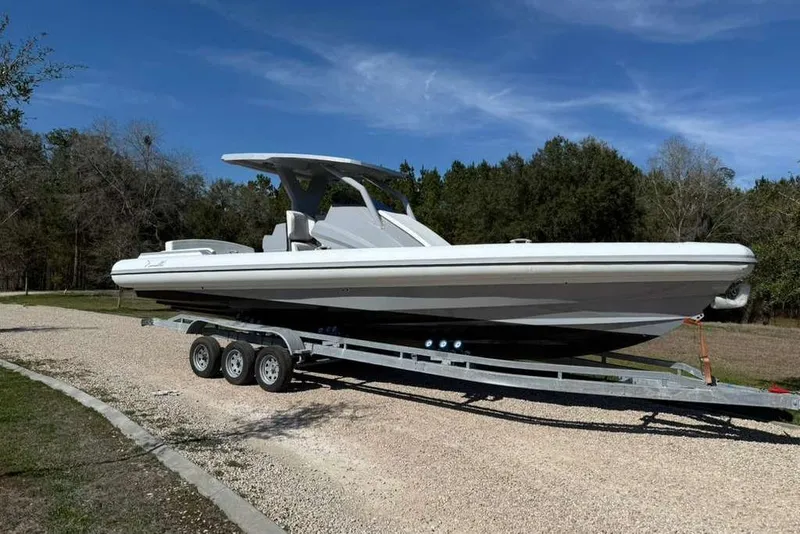 Slide: The Image of 2026 Novielli Veloche 349 boat on trailer, parked outdoors on gravel path. - 8