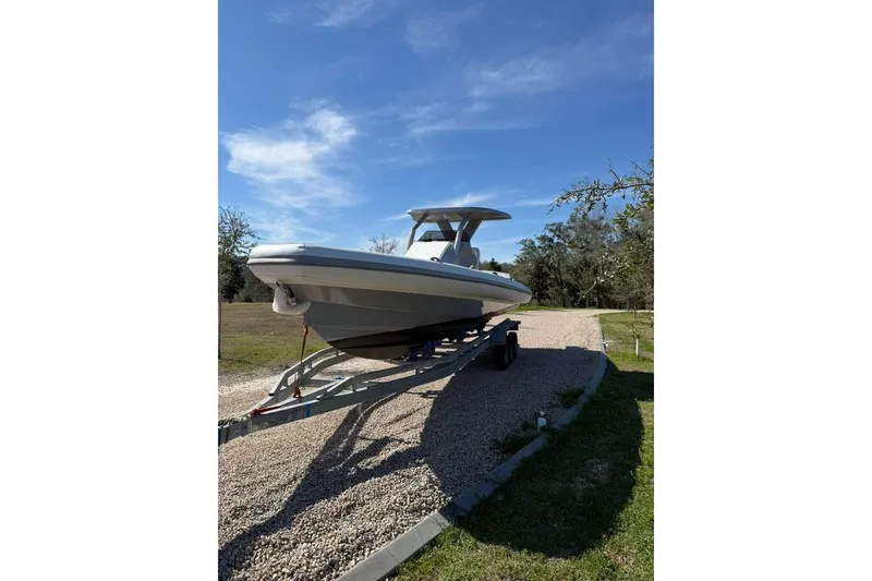 Slide: The Image of 2026 Novielli Veloche 349 boat on trailer under clear blue sky. - 9