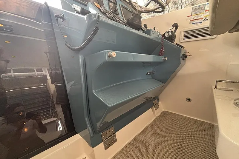 Slide: The Image of Interior view of a 2014 Pursuit SC 365i Sport Coupe boat cockpit area. - 21