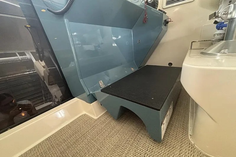 Slide: The Image of Interior view of a 2014 Pursuit SC 365i Sport Coupe, featuring seating and carpeted flooring. - 22