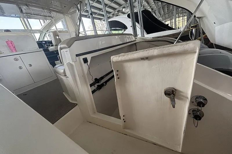 Slide: The Image of 2014 Pursuit SC 365i Sport Coupe interior with open storage compartment. - 23