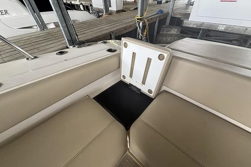 Slide: The Image of 2014 Pursuit SC 365i Sport Coupe interior seating with storage compartment open. - 26