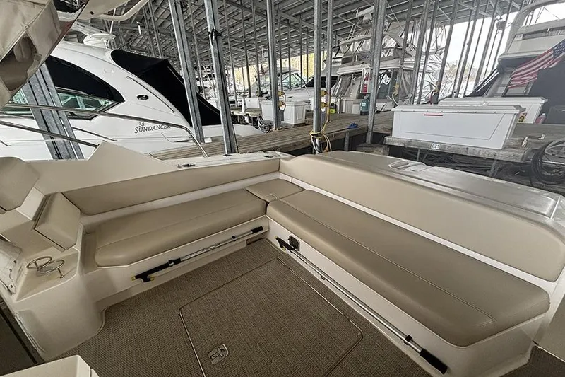 Slide: The Image of 2014 Pursuit SC 365i Sport Coupe interior with beige seating in marina. - 28