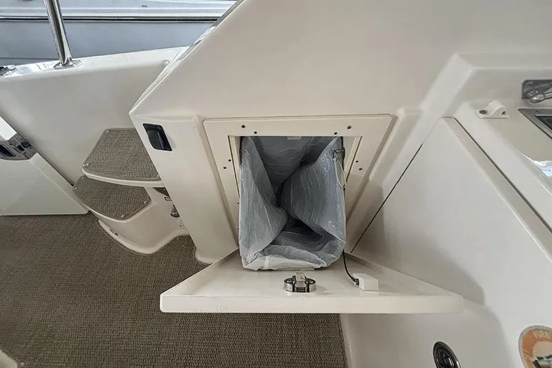 Slide: The Image of 2014 Pursuit SC 365i Sport Coupe interior with open storage compartment. - 35