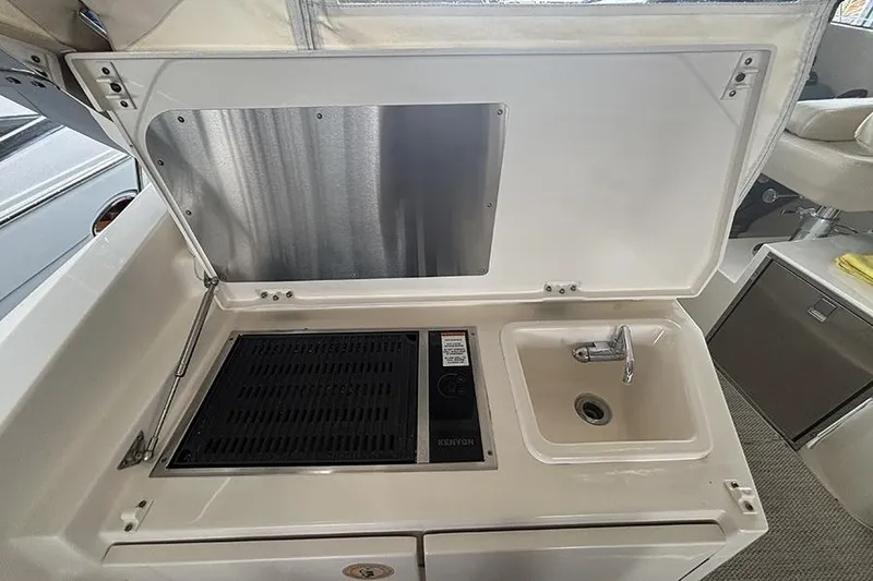Slide: The Image of 2014 Pursuit SC 365i Sport Coupe kitchenette with grill and sink. - 37
