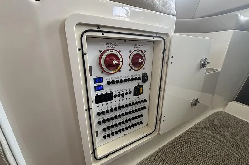 Slide: The Image of Electrical panel inside 2014 Pursuit SC 365i Sport Coupe, featuring switches and controls. - 38